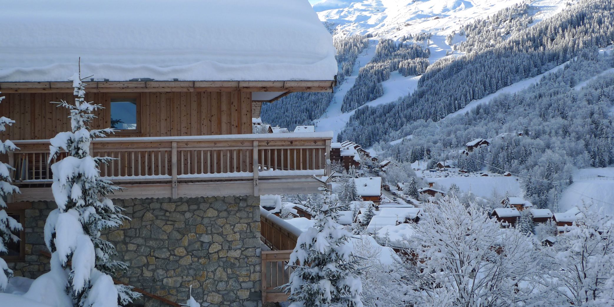 Exterior of a luxury Meribel chalet and view across the valley