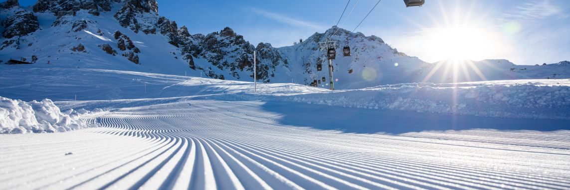 Freshly groomed snow below a ski lift which is perfect for Meribel Beginner Skiing