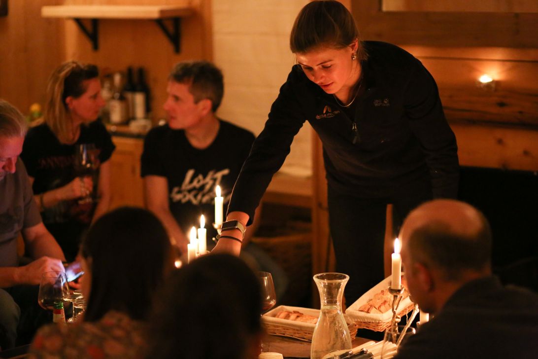 Chalet host serving wine